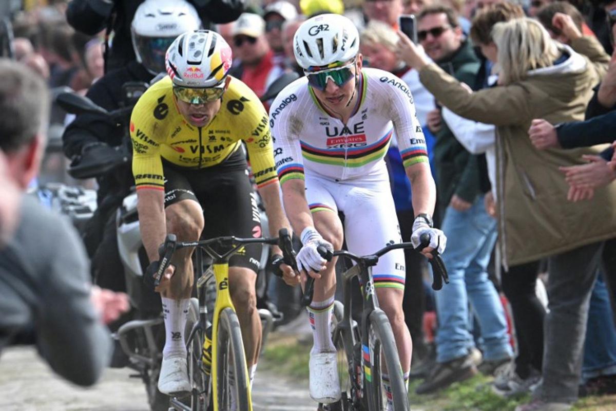 UAE Team Emirates XRG's Slovenian rider Tadej Pogacar cycles in a breakaway on a cobblestone sector ahead of Team Visma - Lease a Bike's Belgian rider Wout van Aert during the 123rd edition of the Paris-Roubaix one-day classic cycling race, 258.3 km between Compiègne and Roubaix, northern France, on April 12, 2026. Bernard PAPON / POOL / AFP