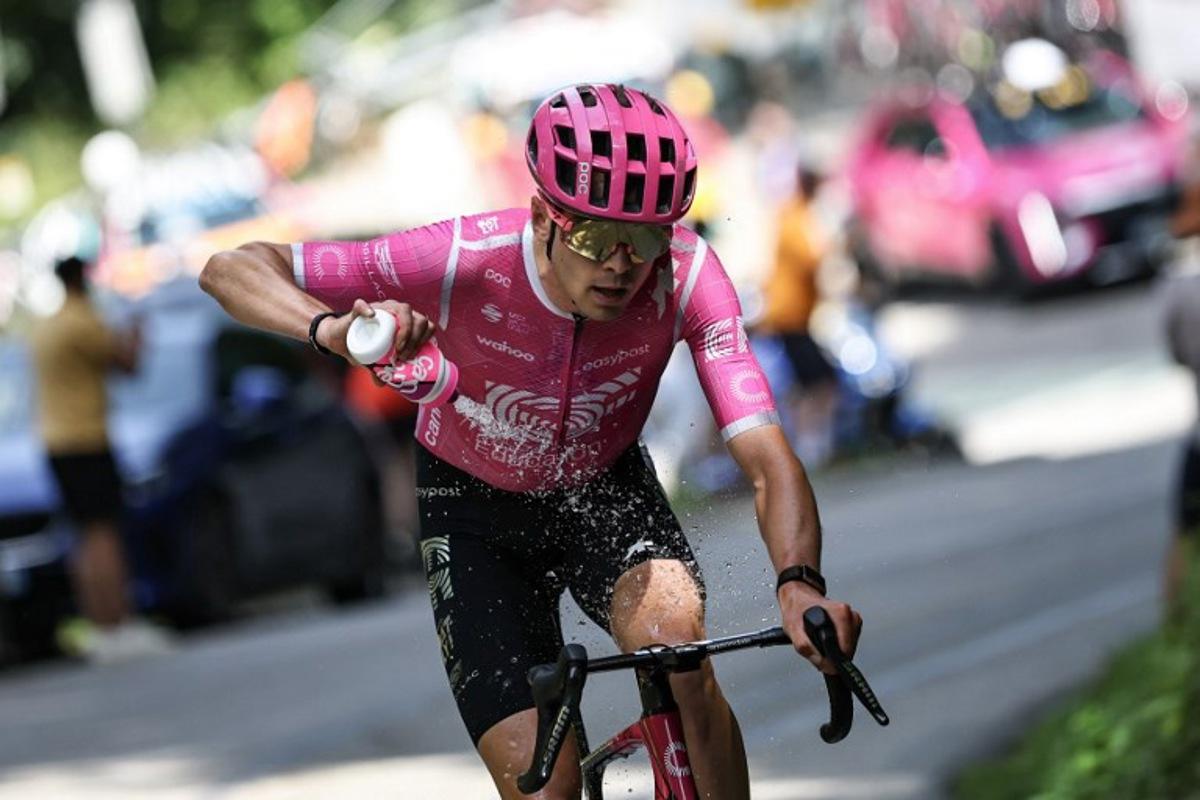 EF Education - EasyPost's French rider Alex Baudin cool down with water as he cycles in a breakaway during the 1st stage of the Tour Auvergne-Rhone-Alpes cycling race (formerly known as the Criterium du Dauphine), 146,2km between Vizille and Saint-Ismier, in the French Alps, on June 7, 2026. Anne-Christine POUJOULAT / AFP