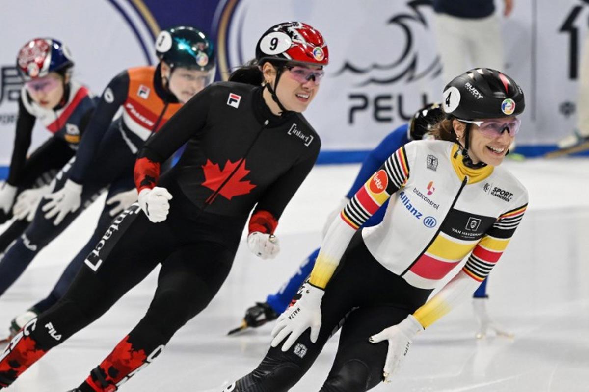 Belgium's Hanne Desmet (R) celebrates after winning the women's 1000 meters final at the ISU World Short Track Championships in Beijing on March 15, 2025. GREG BAKER / AFP