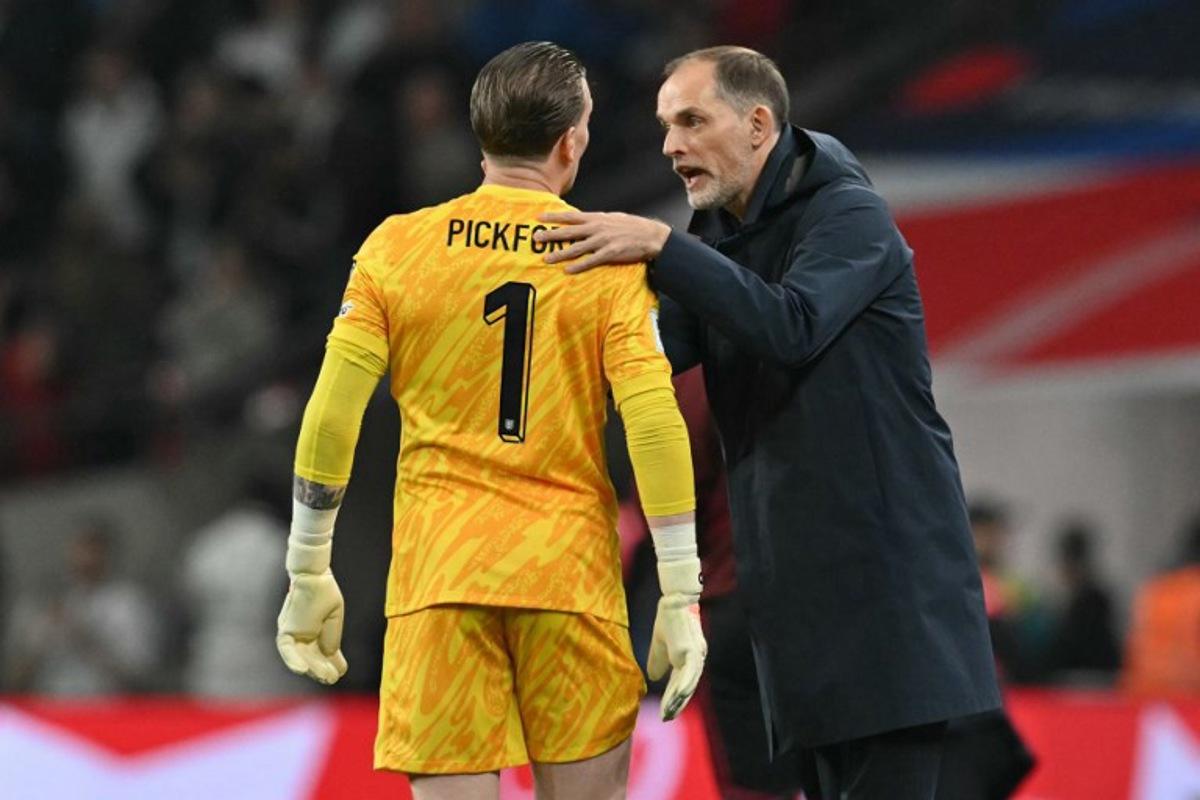 England's German head coach Thomas Tuchel speaks with England's goalkeeper #01 Jordan Pickford during the 2026 World Cup Group K qualifier football match between England and Albania, at Wembley stadium in London, on March 21, 2025. Glyn KIRK / AFP
