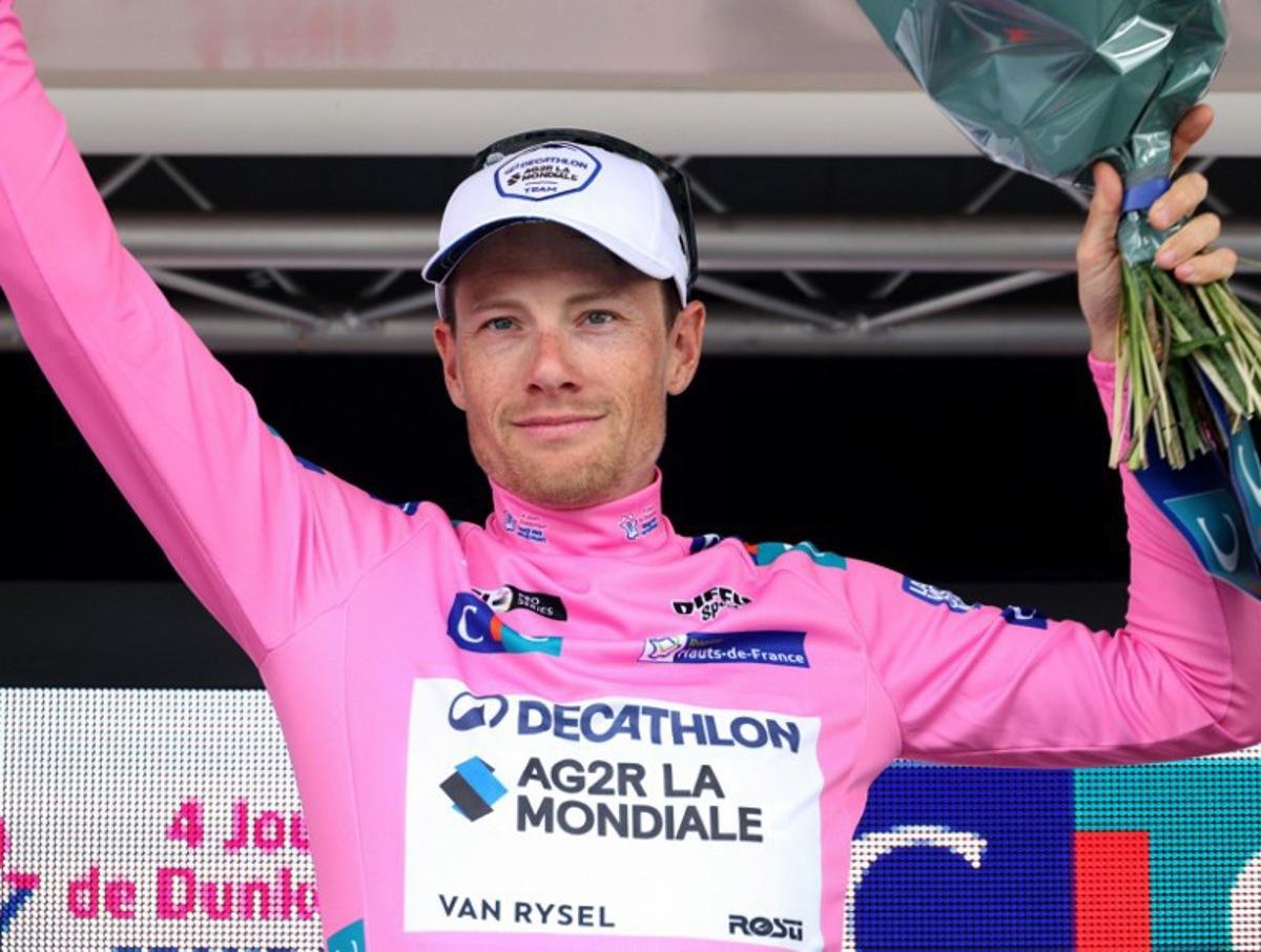 Decathlon AG2R La Mondiale's Irish rider Sam Bennett, wearing the overall leaders pink jersey, celebrates on the podium after the fourth stage of the "4 jours de Dunkerque" (Four days of Dunkirk) cycling race, 171,3 km from Mazingarbe to Pont-a-Marcq, in north France, on May 17, 2024. FRANCOIS LO PRESTI / AFP