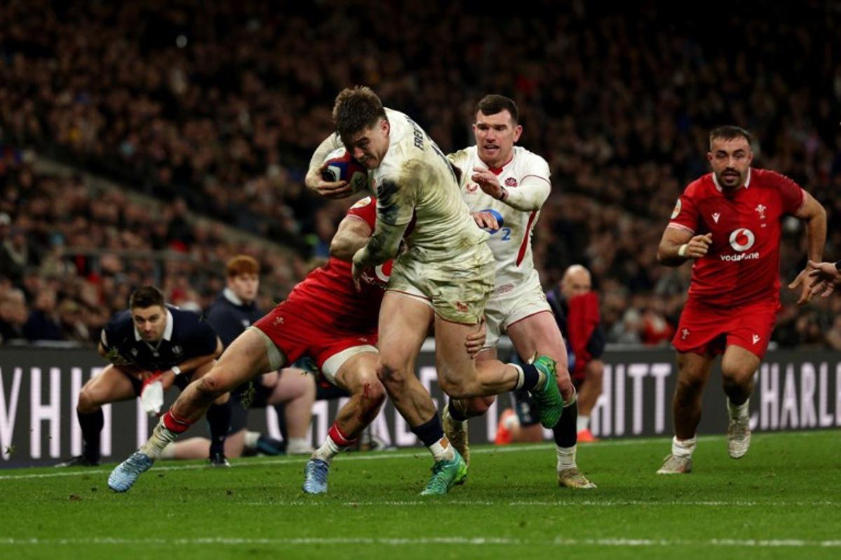 England's centre Tommy Freeman runs to score a try during the Six Nations international rugby union match between England and Wales at Allianz Stadium, Twickenham, in south-west London, on February 7, 2026. Adrian Dennis / AFP