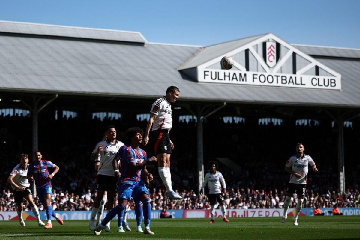 Fulham's Belgian defender #21 Timothy Castagne (C) heads the ball clear during the English FA Cup quarter-final football match between Fulham and Crystal Palace at Craven Cottage in Fulham, west London on March 29, 2025. HENRY NICHOLLS / AFP
