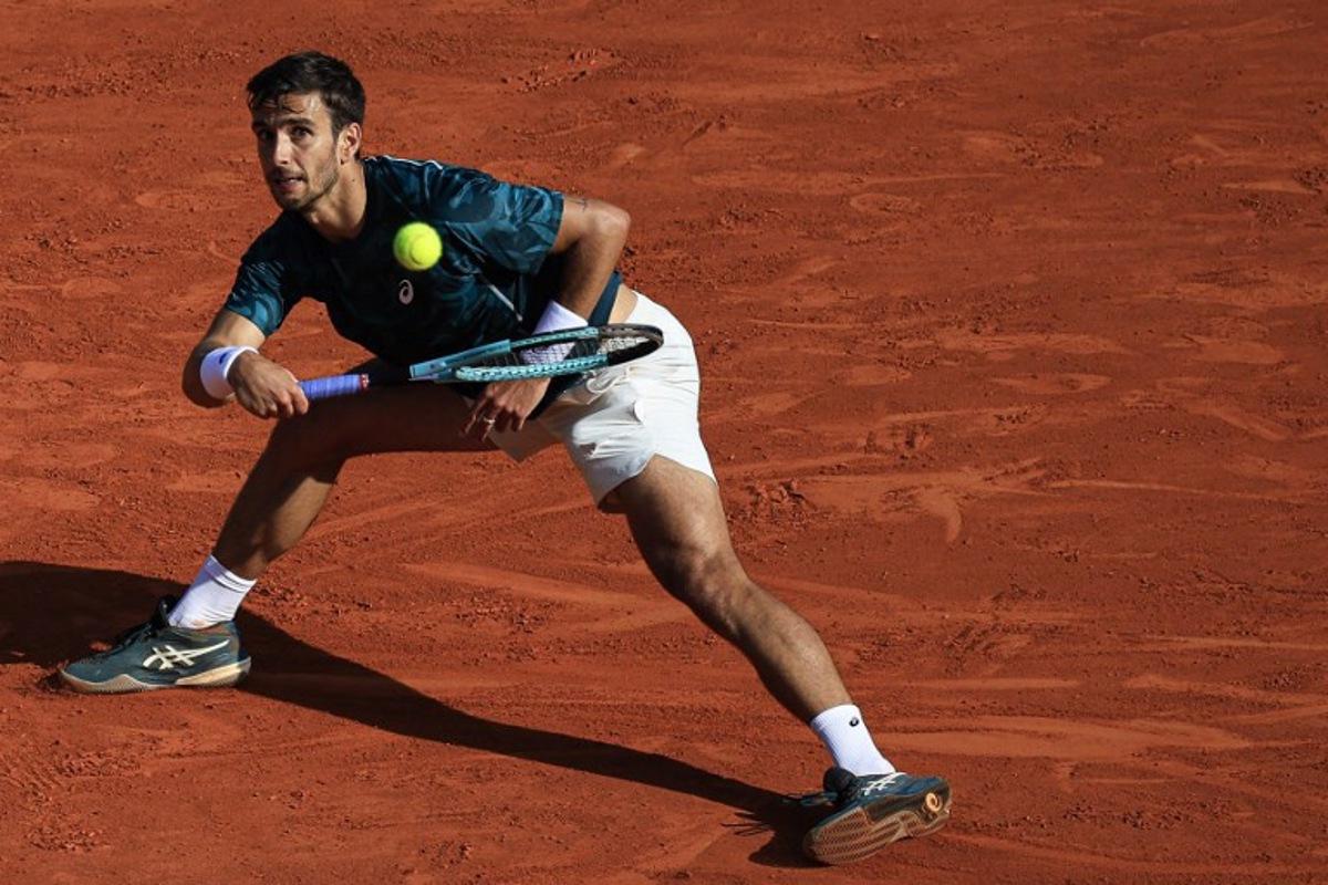 Italy's Lorenzo Musetti returns the ball to Greece's Stefanos Tsitsipas during the Monte Carlo ATP Masters Series Tournament quarter-final tennis match at the Monte Carlo Country Club in Roquebrune-Cap-Martin on April 11, 2025. Valery HACHE / AFP