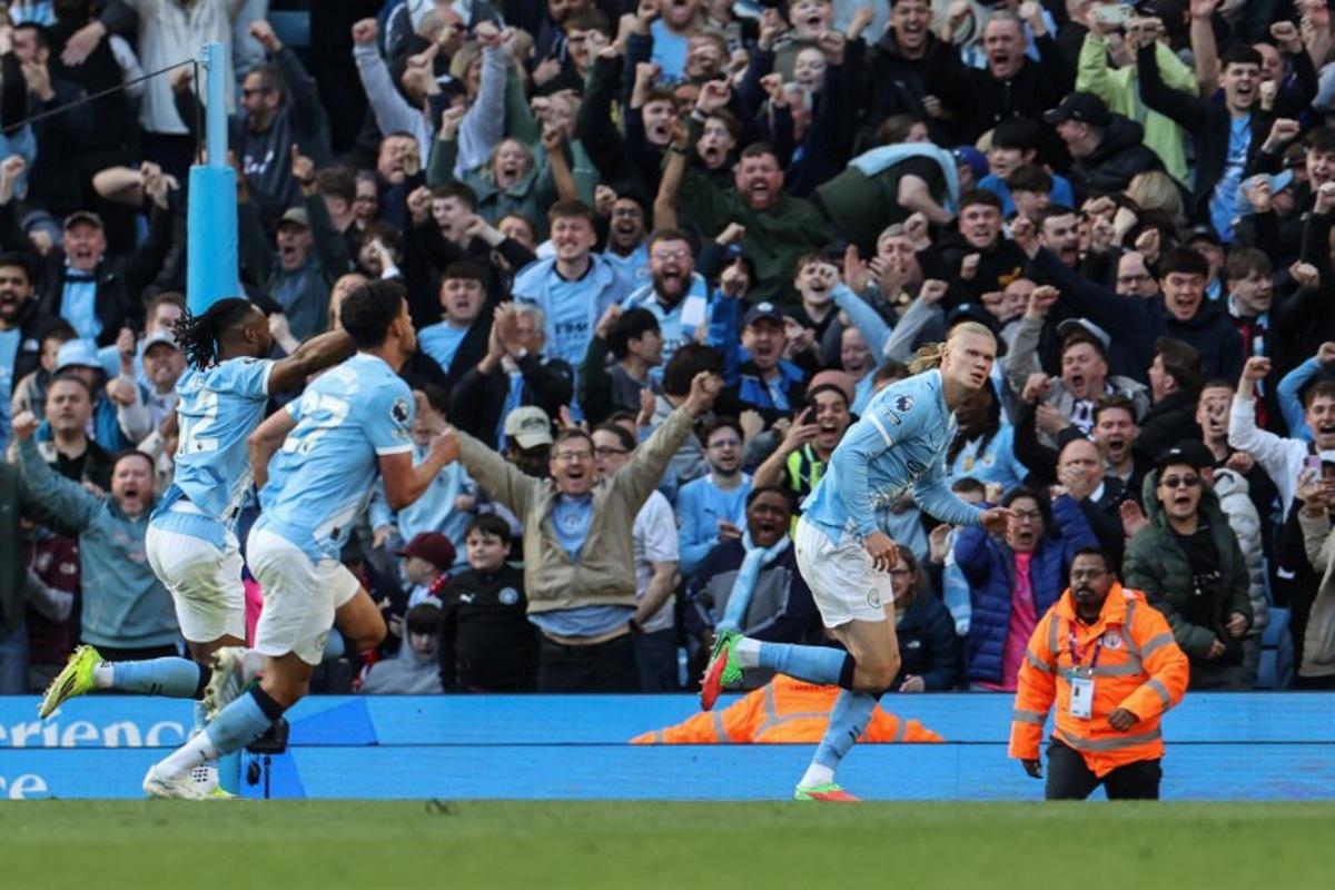 Manchester City's Norwegian striker #09 Erling Haaland (R) celebrates after scoring his team's second goal during the English Premier League football match between Manchester City and Arsenal at the Etihad Stadium in Manchester, north west England, on April 19, 2026. Darren Staples / AFP