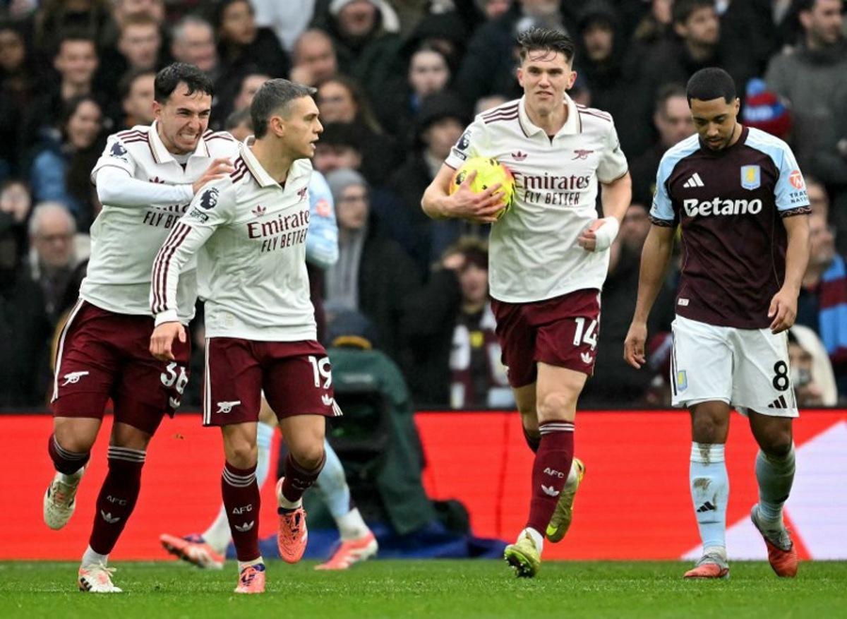 Arsenal's Belgian midfielder #19 Leandro Trossard (2L) celebrates after scoring the equalising goal during the English Premier League football match between Aston Villa and Arsenal at Villa Park in Birmingham, central England on December 6, 2025. JUSTIN TALLIS / AFP