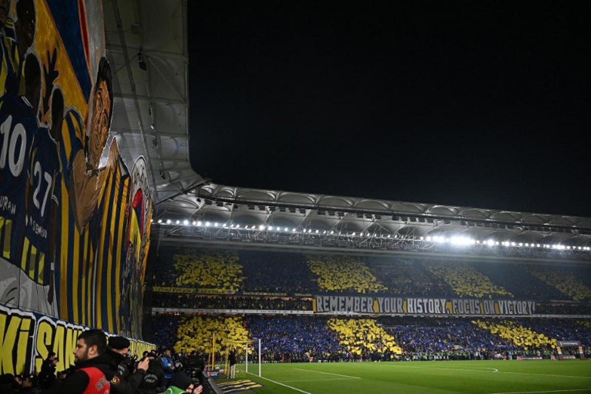 Fenerbahce's fans cheers for their team before the Turkish Super lig football match between Fenerbahce and Galatasaray at the Fenerbahce Sukru Saracoglu stadium in Istanbul, on December 1, 2025. Ozan KOSE / AFP