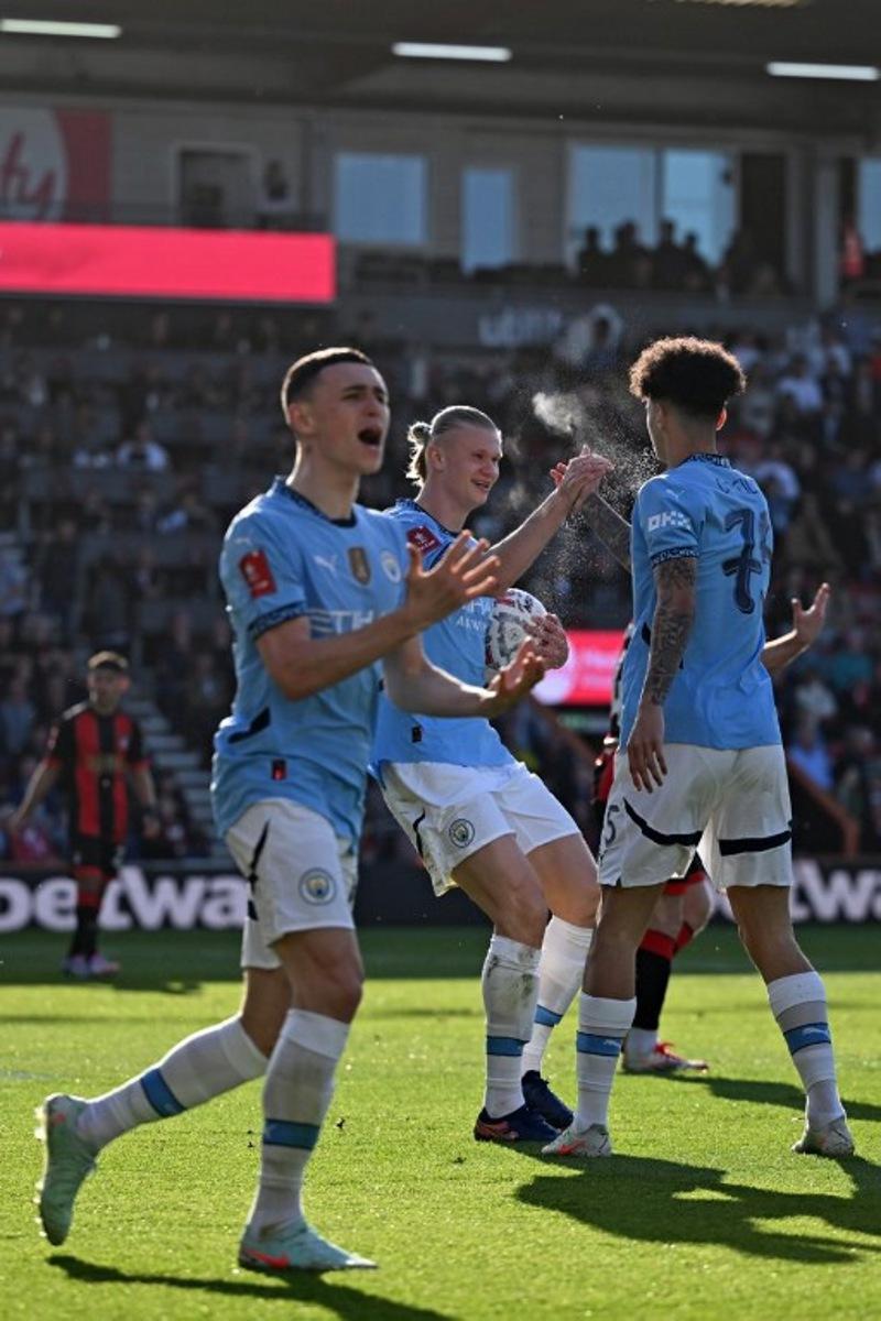 Manchester City's Norwegian striker #09 Erling Haaland (C) celebrates with Manchester City's English midfielder #75 Nico O'Reilly (R) after the two combine for their first goal during the English FA Cup quarter-final football match between Bournemouth and Manchester City at the Vitality Stadium in Bournemouth, on the south coast of England on March 30, 2025. JUSTIN TALLIS / AFP