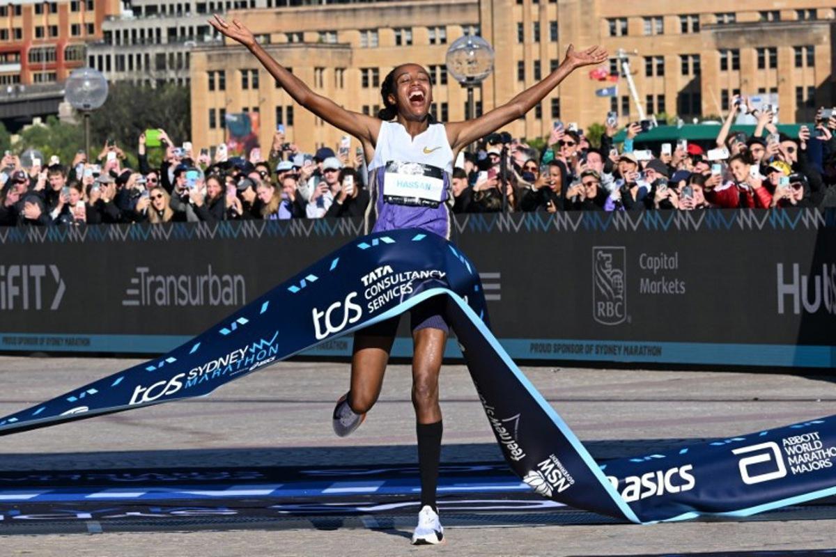 Netherlands's Sifan Hassan crosses the finish line first in the 2025 Sydney Marathon, crossing the iconic Harbour Bridge on August 31, 2025. Saeed KHAN / AFP