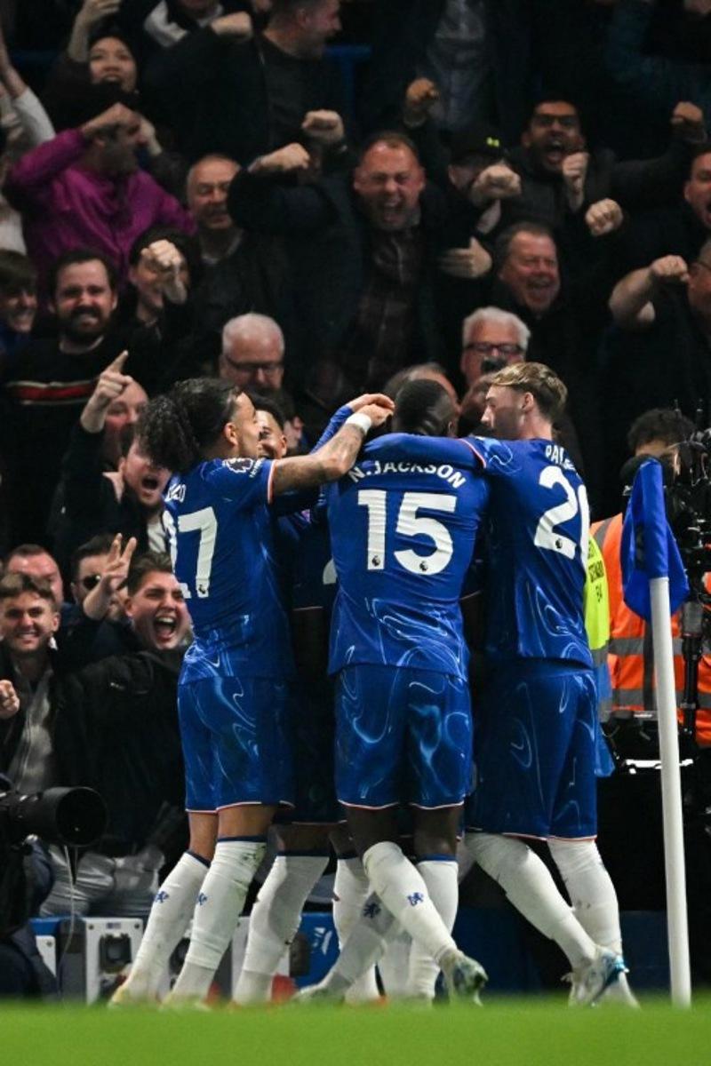 Chelsea's Ecuadorian midfielder #25 Moises Caicedo (unseen) celebrates with teammates after scoring his team second goal that will be disallowed due to a foul during the English Premier League football match between Chelsea and Tottenham Hotspur at Stamford Bridge in London on April 3, 2025. Glyn KIRK / AFP
