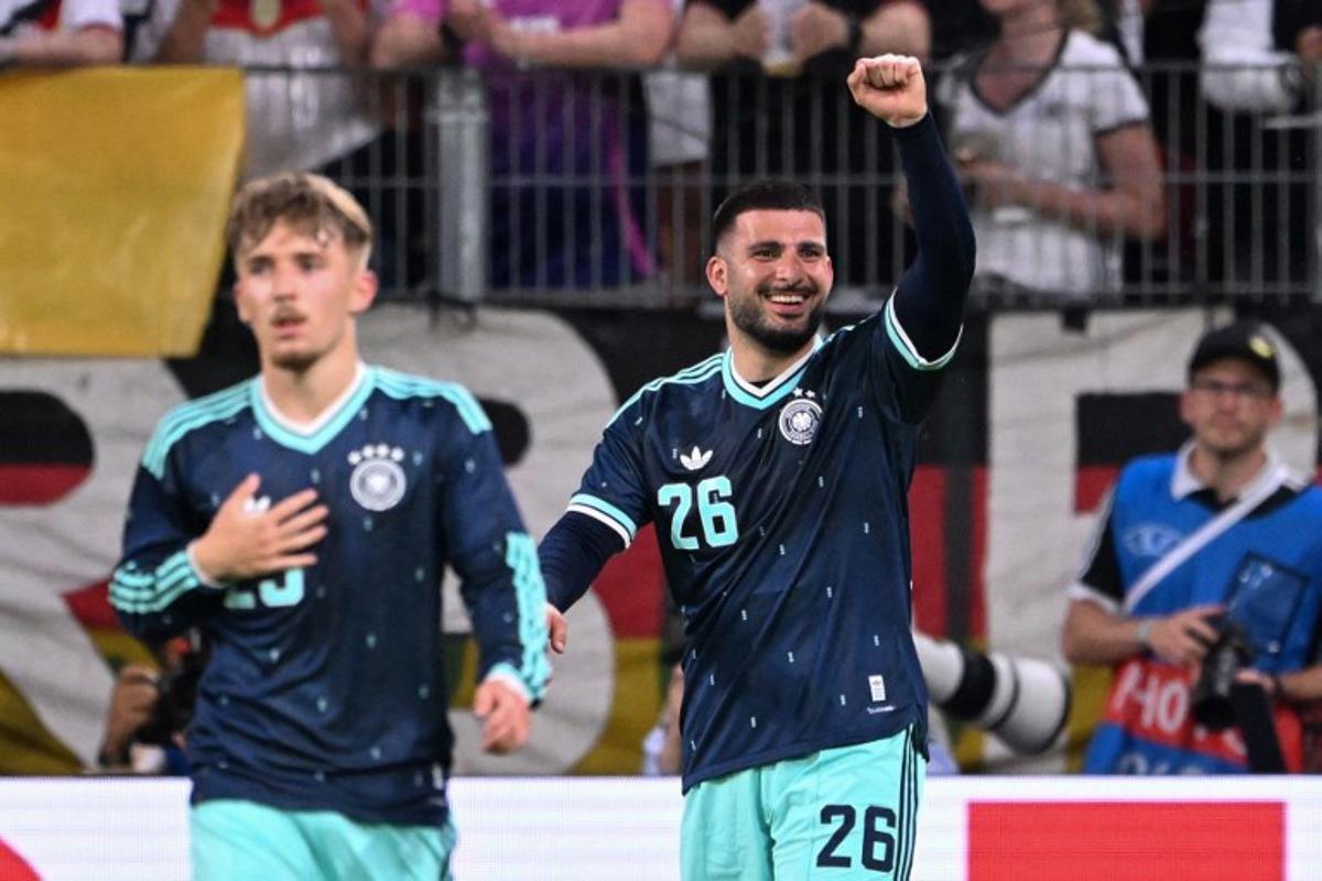 Germany's forward #26 Deniz Undav (R) celebrates scoring his team's first goal with Germany's midfielder #25 Lennart Karl during a friendly match between Germany and Finland ahead of the 2026 FIFA World Cup football tournament, in Mainz, western Germany on May 31, 2026. Kirill KUDRYAVTSEV / AFP