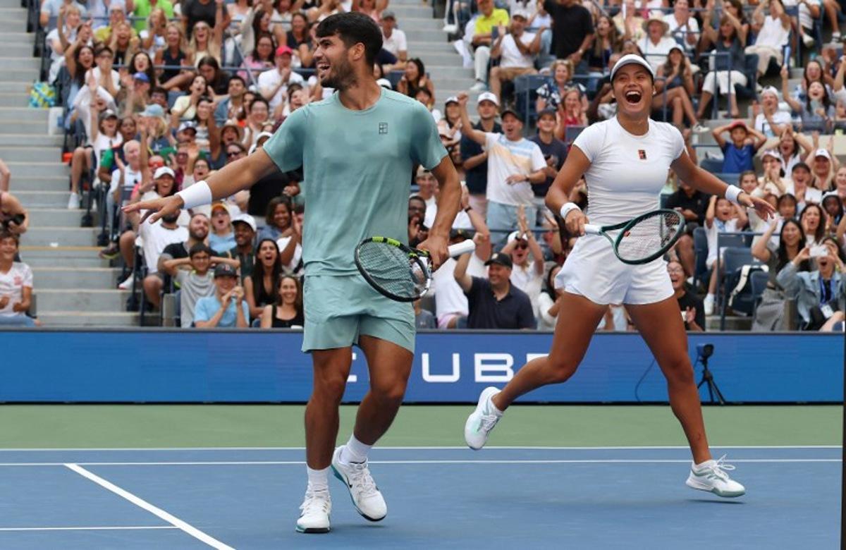 Britain's Emma Raducanu and Carlos Alcaraz of Spain celebrate a point during their first round mixed doubles match against Jessica Pegula of the US and Jack Draper of Britain at the US Open tennis tournament at the USTA Billie Jean King National Tennis Center in New York City on August 19, 2025. TIMOTHY A. CLARY / AFP