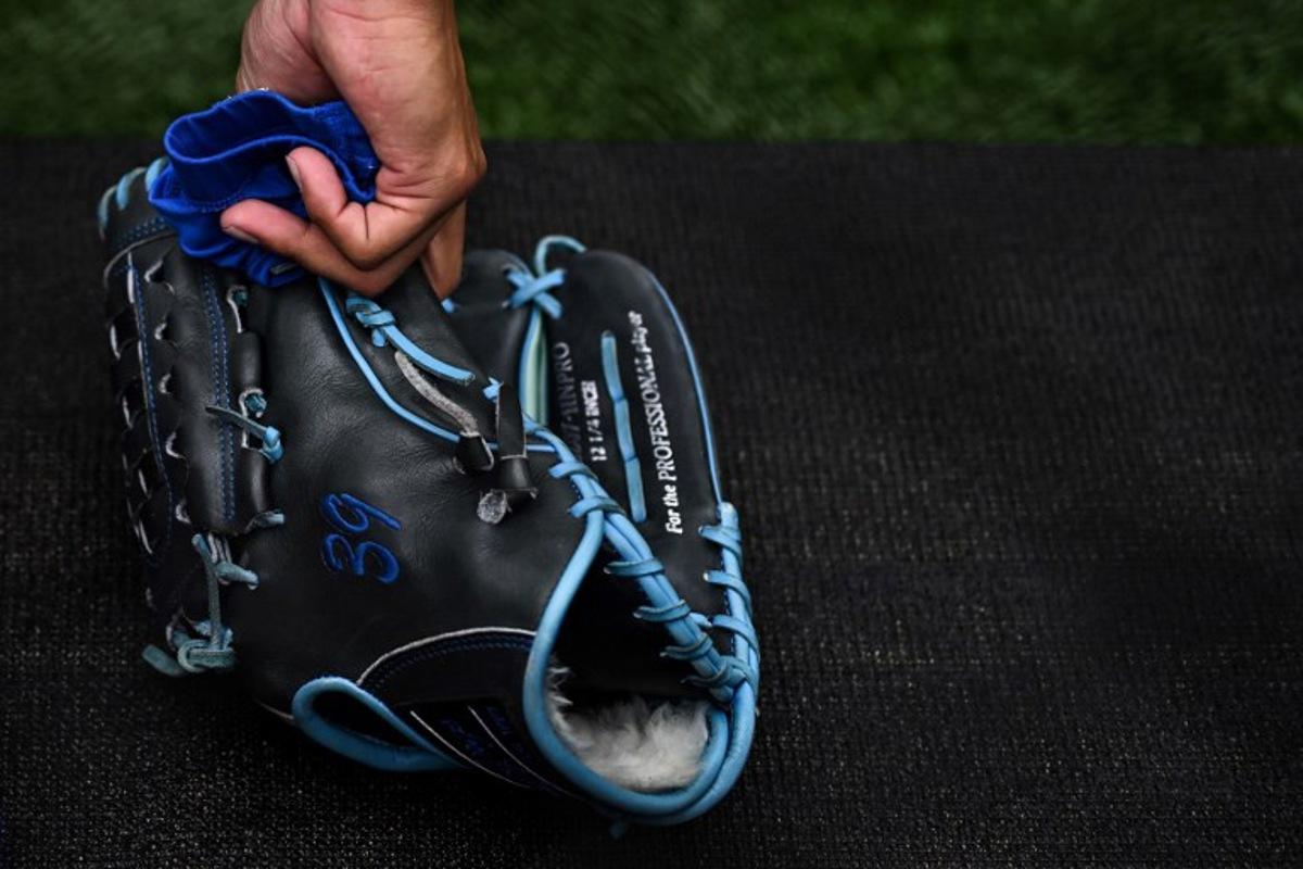 St. Louis Cardinals pitcher Miles Mikolas picks up his glove during the practise prior to the first of the two-game, 2023 major league baseball London Series between the St. Louis Cardinals and the Chicago Cubs at London Stadium in east London on June 24, 2023. Ben Stansall / AFP