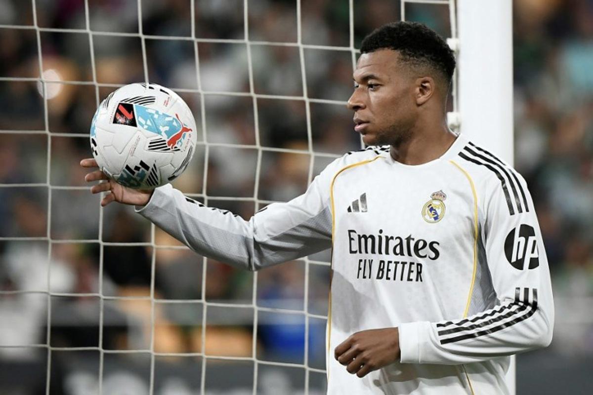 Real Madrid's French forward #10 Kylian Mbappe handles the ball during the Spanish league football match between Real Betis and Real Madrid CF at the La Cartuja stadium in Seville on April 24 , 2026. CRISTINA QUICLER / AFP