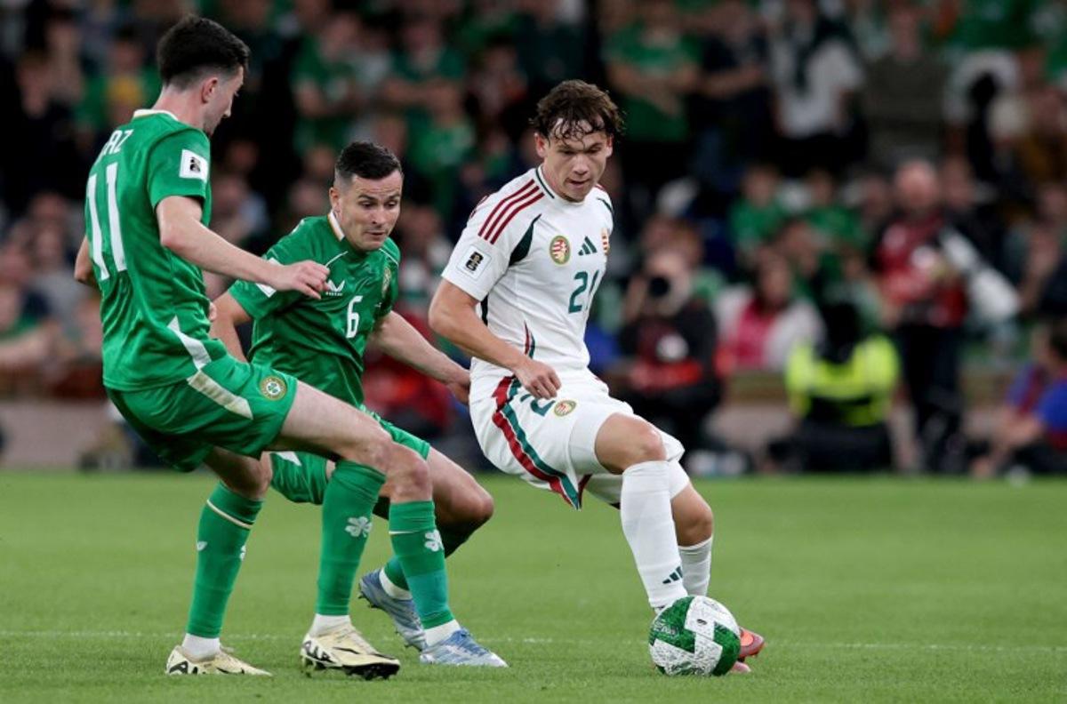 Republic of Ireland's midfielder #11 Finn Azaz battles for the ball with Hungary's midfielder #21 Alex Toth during the 2026 World Cup Group F qualifier football match between Republic of Ireland and Hungary, at Aviva Stadium, in Dublin, on September 6, 2025. Paul Faith / AFP
