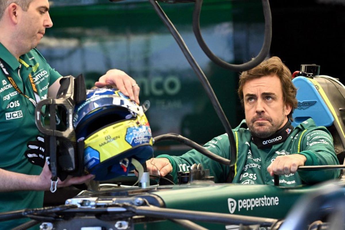 Aston Martin's Spanish driver Fernando Alonso inspects his car with team mechanics in the garage ahead of the Formula One Australian Grand Prix at Melbourne's Albert Park on March 5, 2026. Paul Crock / AFP