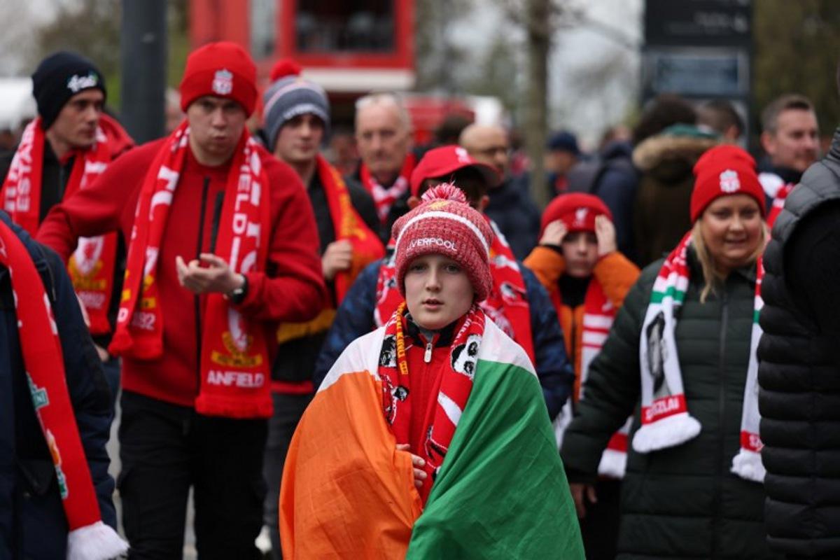 Liverpool fans arrive for the UEFA Champions League quarter final, second-leg football match between Liverpool and Paris Saint-Germain at Anfield in Liverpool, north west England on April 14, 2026. FRANCK FIFE / AFP