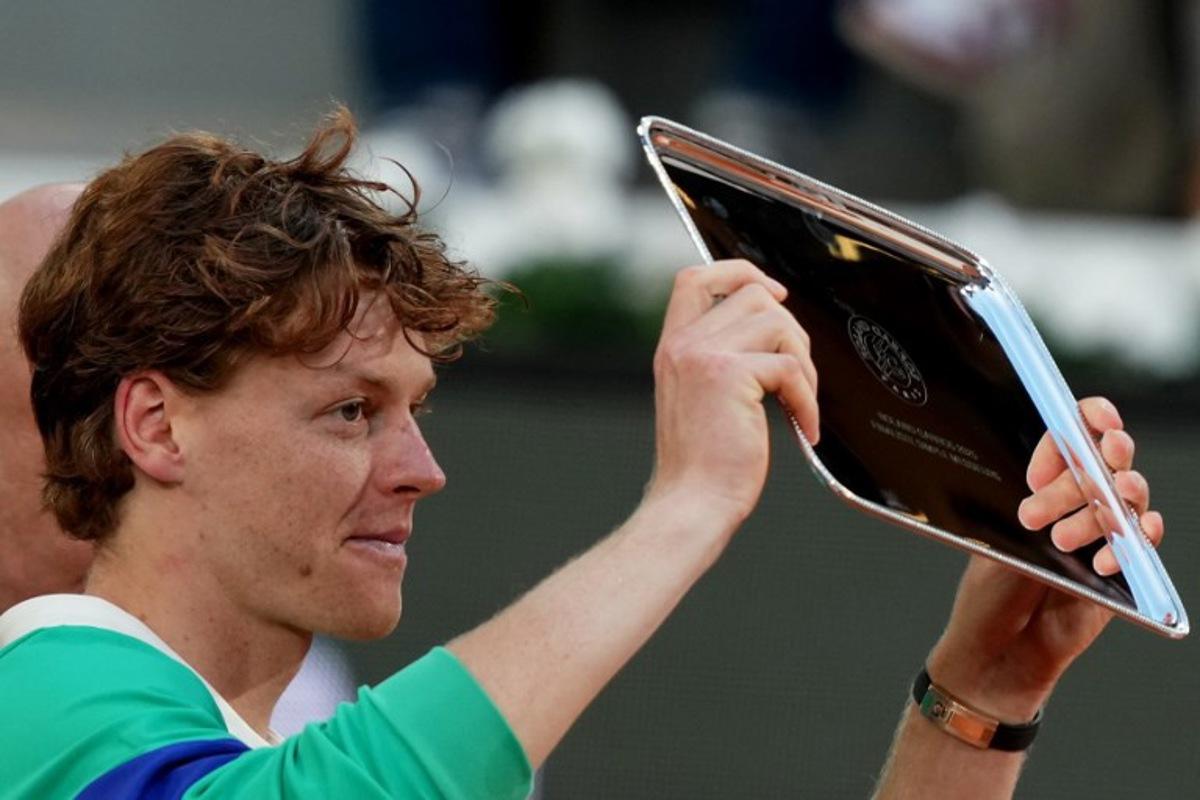 Second-placed Italy's Jannik Sinner holds his trophy after his defeat in the men's singles final match against Spain's Carlos Alcaraz on day 15 of the French Open tennis tournament on Court Philippe-Chatrier at the Roland-Garros Complex in Paris on June 8, 2025. Dimitar DILKOFF / AFP