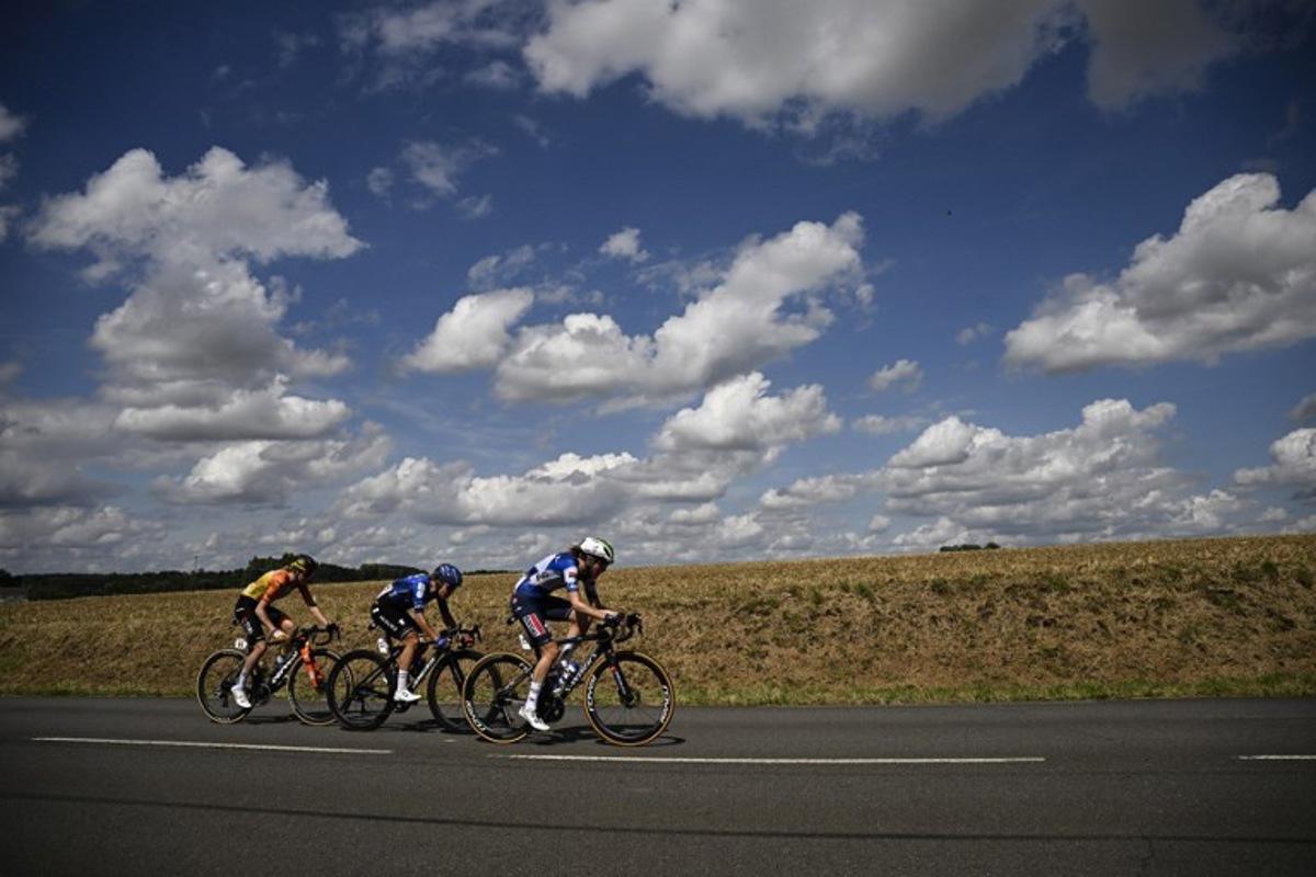 AG Insurance - Soudal Team's Belgian rider Julie Van De Velde, Team Visma | Lease a Bike's Dutch rider Femke de Vries and Team Visma | Lease a Bike's Dutch rider Fem van Empel cycle in a breakaway during the 5th stage (out of 8) of the third edition of the Women's Tour de France cycling race, a 152.5 km between Bastogne in southeastern Belgium and Amneville in northeastern France, on August 15, 2024. JULIEN DE ROSA / AFP