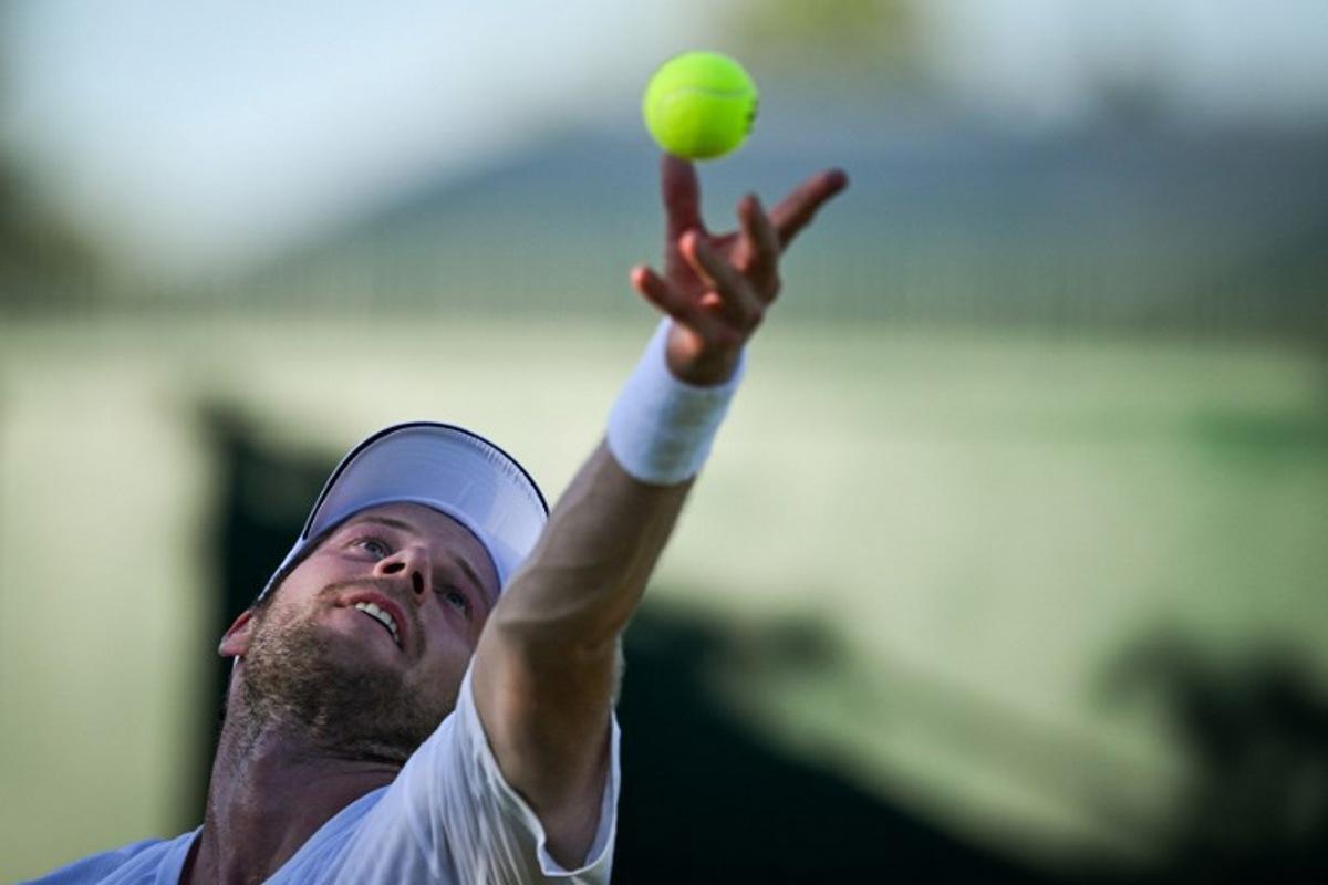 Netherlands' Botic Van De Zandschulp serves the ball to Italy's Matteo Arnaldi during their men's singles first round tennis match on the first day of the 2025 Wimbledon Championships at The All England Lawn Tennis and Croquet Club in Wimbledon, southwest London, on June 30, 2025. Kirill KUDRYAVTSEV / AFP