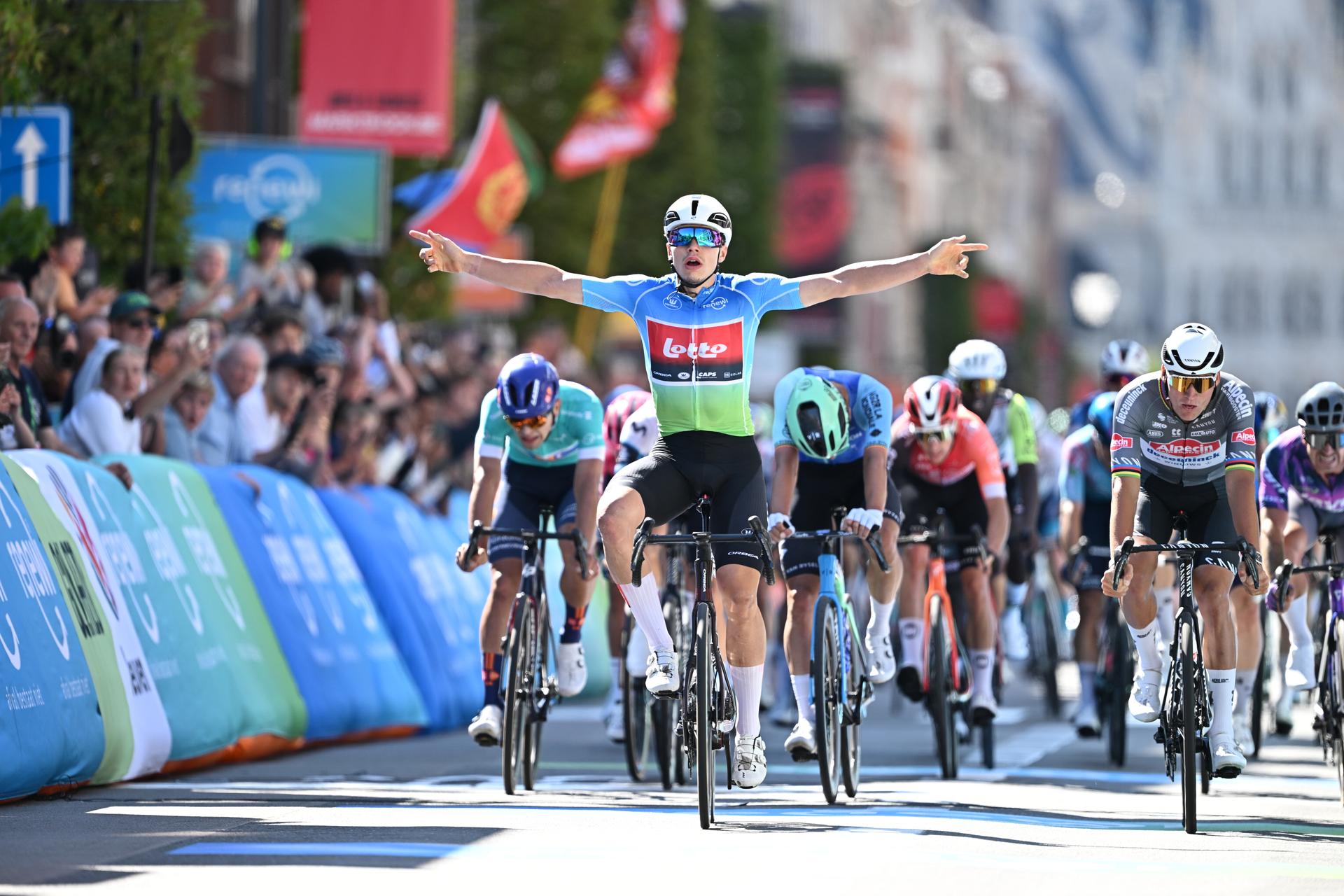 Belgian Arnaud De Lie of Lotto Cycling Team (C) celebrates as he wins before Dutch Mathieu van der Poel of Alpecin-Deceuninck (R) the sprint at the finish of the fifth and last stage of the 'Renewi Tour' multi-stage cycling race, 185km from and to Leuven on Sunday 24 August 2025. The five-day race takes place in Belgium and the Netherlands. BELGA PHOTO DAVID PINTENS