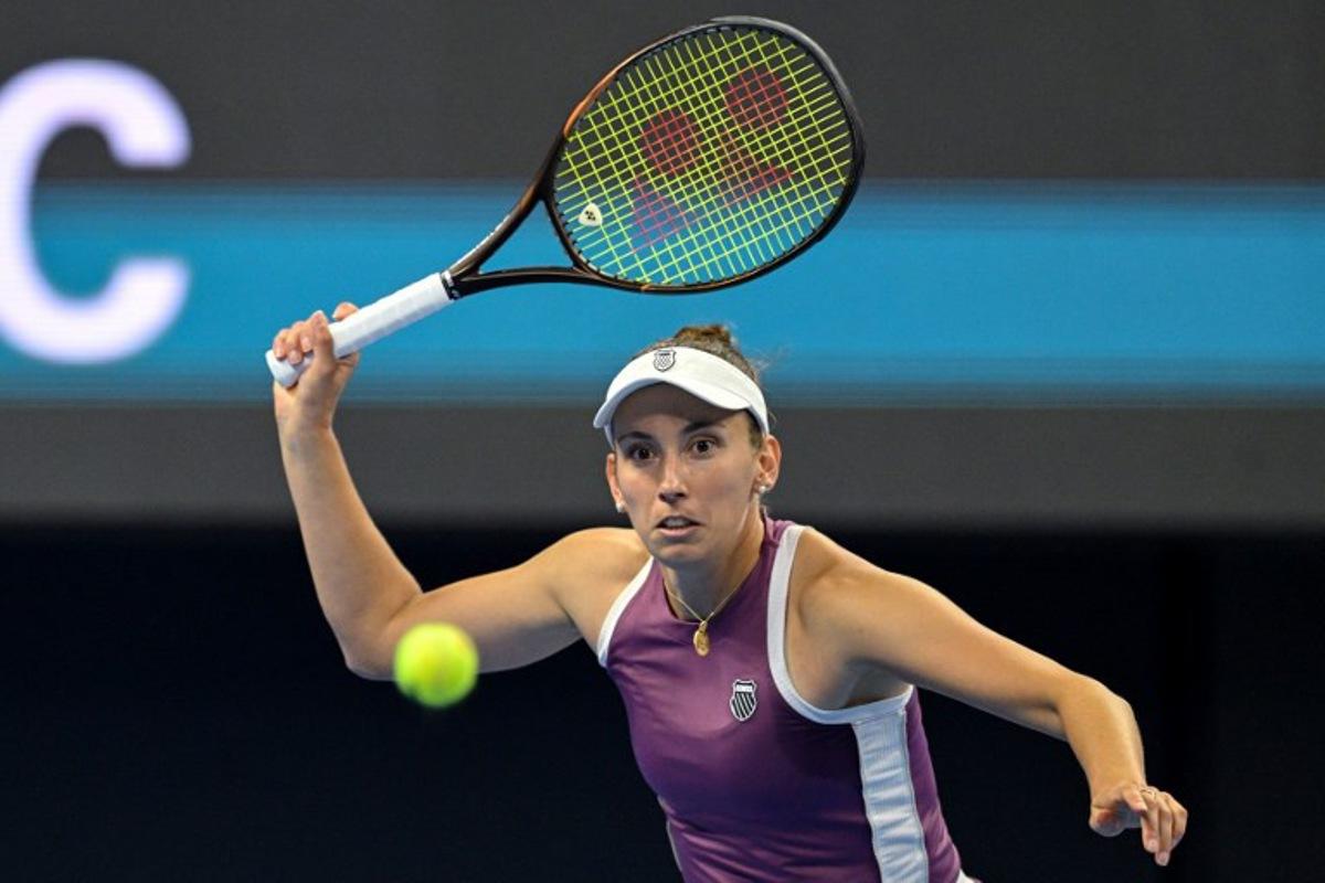 Belgium's Elise Mertens hits a return to Poland's Iga Swiatek during their women's singles quarter-final at the China Open tennis tournament in Beijing on October 9, 2026. GREG BAKER / AFP