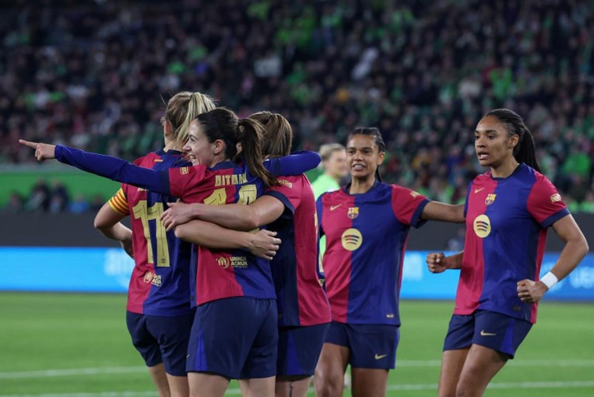 Barcelona players including Spanish midfielder #14 Aitana Bonmati (2nd L) celebrate the opening goal during the UEFA Women's Champions League quarter-final first-leg football match VfL Wolfsburg v FC Barcelona in Wolfsburg, northern Germany, on March 19, 2025. Ronny HARTMANN / AFP