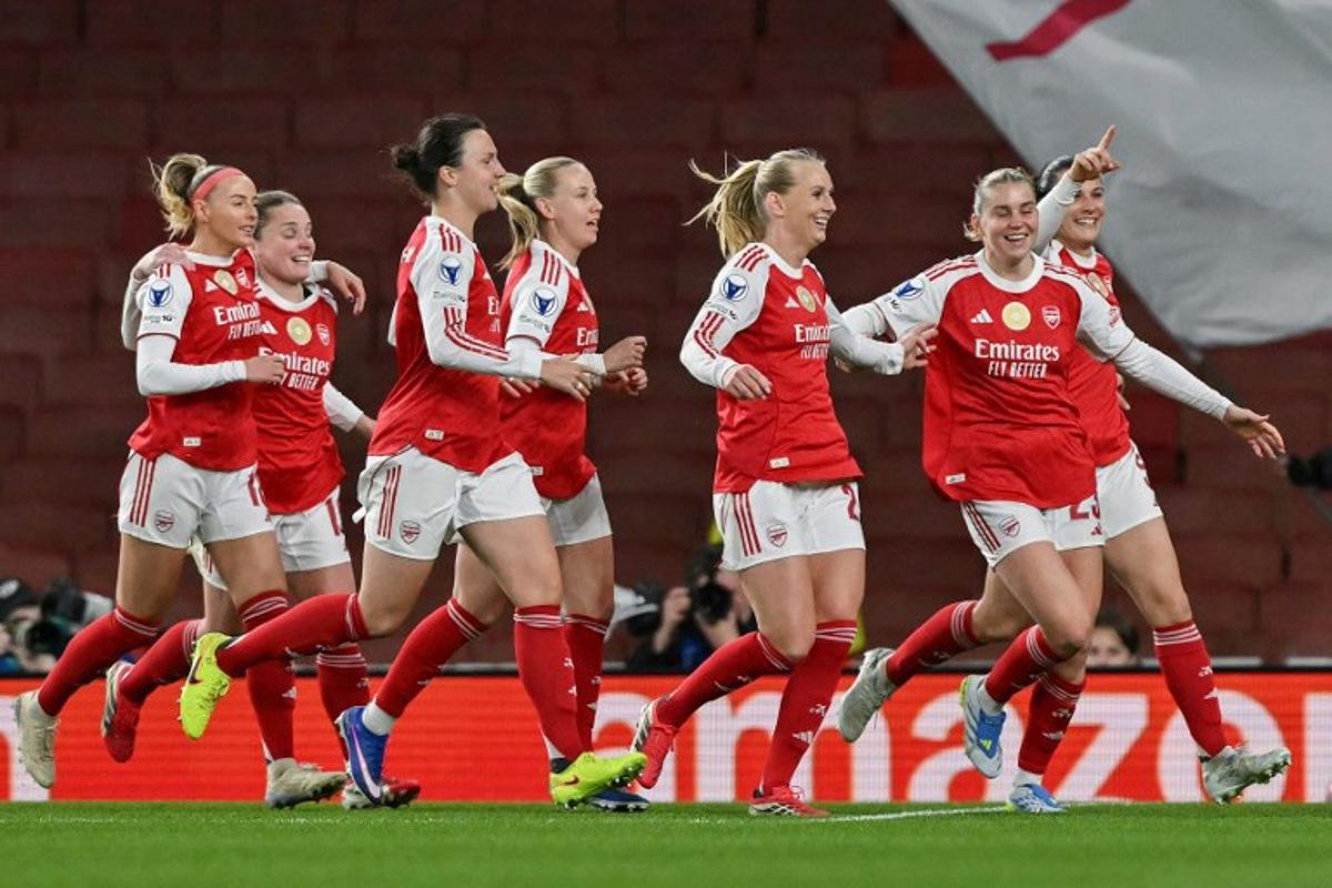Teammates celebrate after Arsenal's Swedish striker #25 Stina Blackstenius scored the team's first goal during the UEFA Women's Champions League quarter-final 1st leg football match between Arsenal and Chelsea at The Emirates Stadium in London on March 24, 2026. Glyn KIRK / AFP