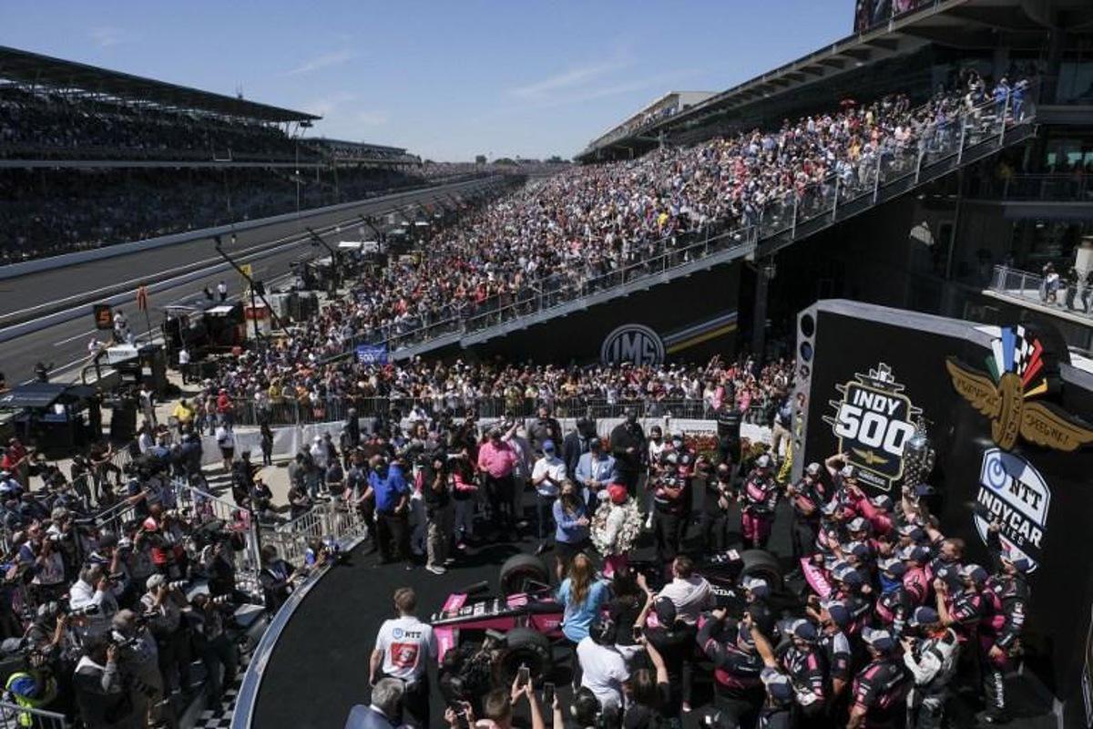 Helio Castroneves(C) celebrates with team members after becoming the fourth driver in history to win the Indianapolis 500 auto race four times at Indianapolis Motor Speedway on May 30, 2021 in Indianapolis. Brazil's Helio Castroneves matched the all-time record by winning his fourth career Indianapolis 500 on Sunday, holding off Alex Palou over the final laps for the victory at age 46. Castroneves -- who also won in 2001, 2002 and 2009 -- joined US legends AJ Foyt, Al Unser Sr and Rick Mears as four-time winners over 200 laps at the famed 2.5-mile (4km) Indianapolis Motor Speedway oval. Jeff Dean / AFP