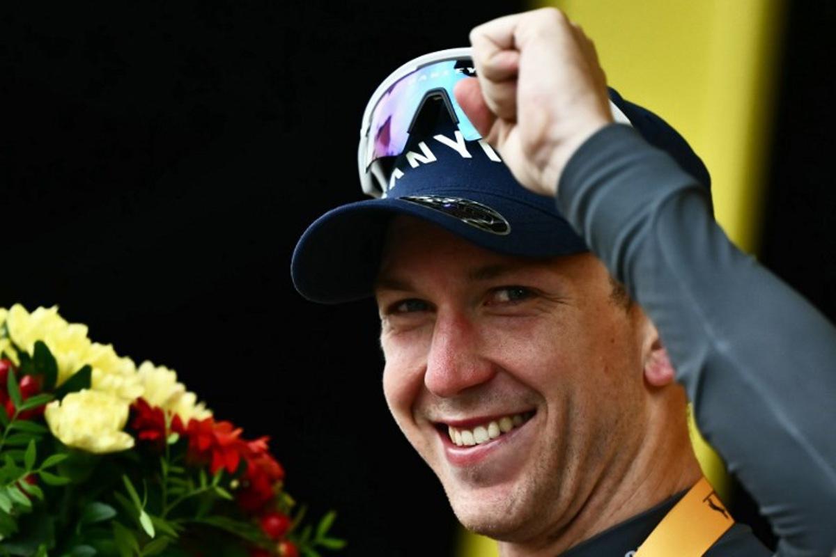 Alpecin - Deceuninck team's Australian rider Kaden Groves celebrates on the podium after winning the 20th stage of the 112th edition of the Tour de France cycling race, 184.2 km between Nantua and Pontarlier, in the Jura, eastern France, on July 26, 2025. Marco BERTORELLO / AFP