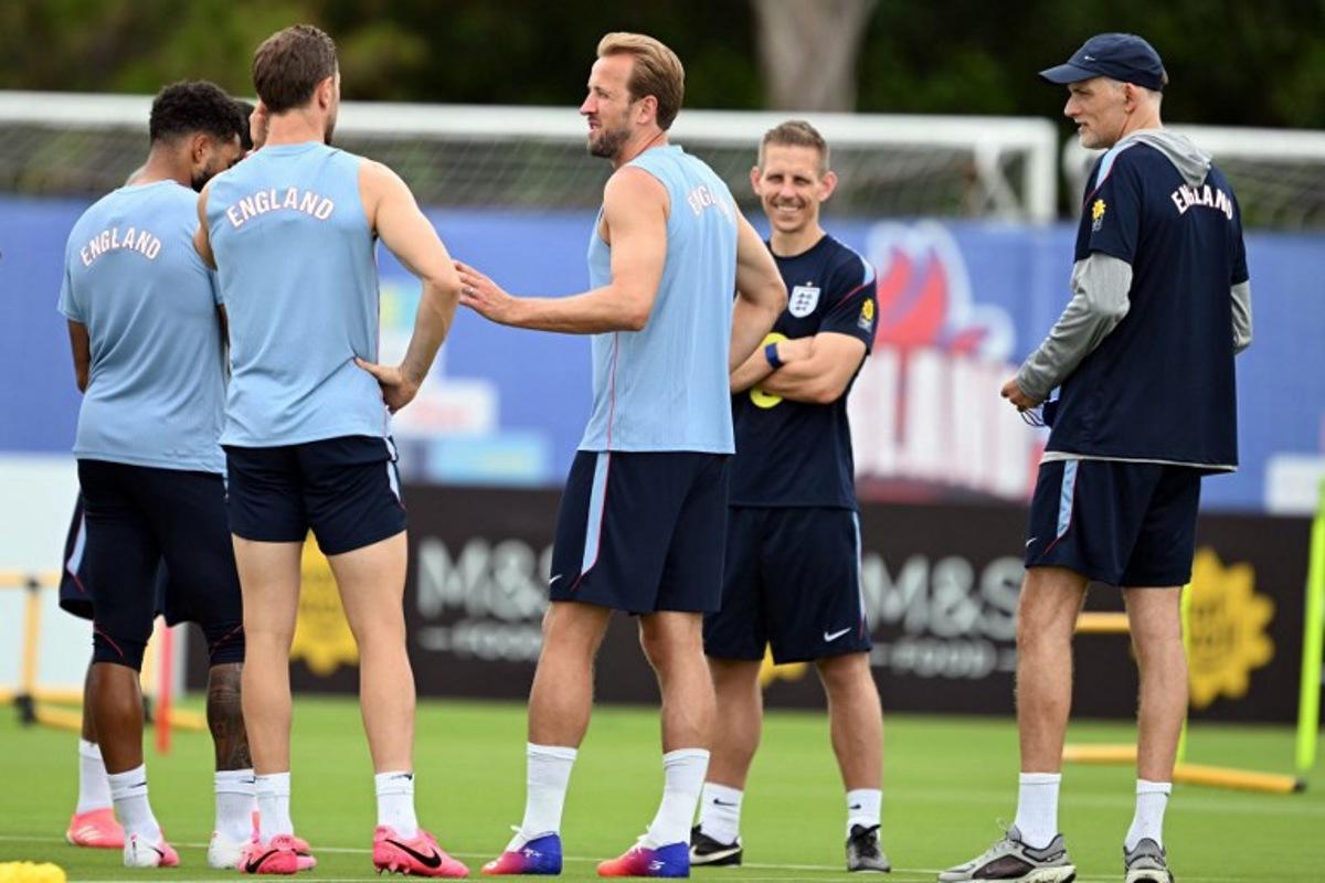 England's forward #09 Harry Kane (C) speaks with teammates as England's German head coach Thomas Tuchel (R) looks on during a training session as part of the team's preparation for its FIFA World Cup football tournament opening match against Croatia at the team's training camp in Palm Beach Gardens on June 9, 2026. CHANDAN KHANNA / AFP