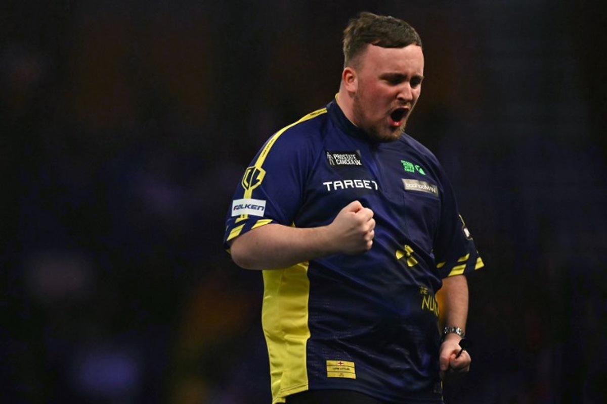 England's Luke Littler celebrates winning the fourth set against Netherlands' Michael van Gerwen during the PDC World Darts Championship final, at Alexandra Palace in London on January 3, 2025. Ben STANSALL / AFP