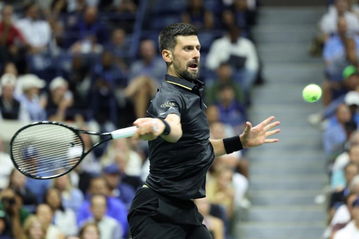 Serbia's Novak Djokovic hits a forehand return to Britain's Cameron Norrie during their men's singles third round match on day six of the US Open tennis tournament at the USTA Billie Jean King National Tennis Center in New York City on August 29, 2025. CHARLY TRIBALLEAU / AFP