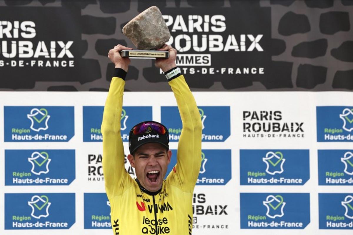 Winner Team Visma - Lease a Bike's Belgian rider Wout van Aert celebrates on the podium of the 123rd edition of the Paris-Roubaix one-day classic cycling race, 258.3 km between Compiègne and Roubaix, at the Vélodrome André-Pétrieux in Roubaix, northern France, on April 12, 2026. Anne-Christine POUJOULAT / AFP