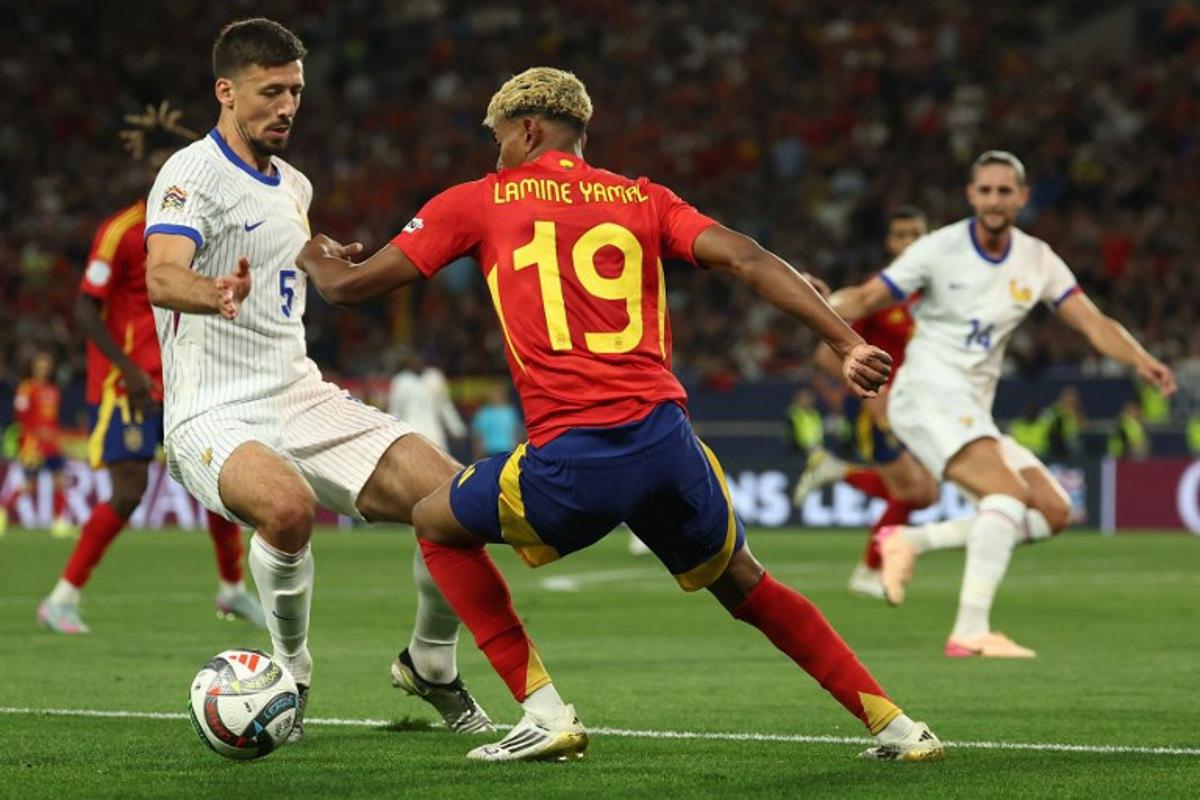 Spain's forward #19 Lamine Yamal (C) and France's defender #05 Clement Lenglet vie for the ball during the UEFA Nations League semi-final football match between Spain and France in Stuttgart, southwestern Germany, on June 5, 2025. FRANCK FIFE / AFP