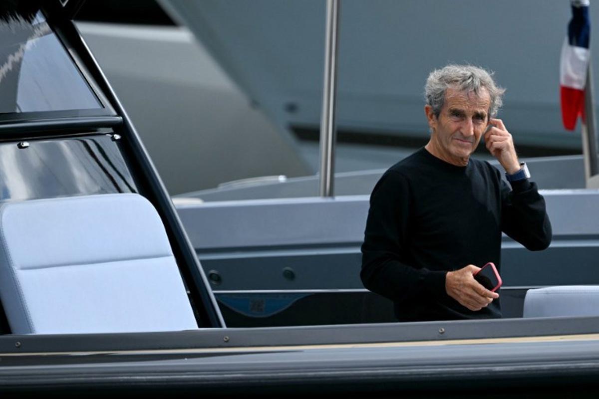 French former driver Alain Prost arrives by boat in the paddock of the Circuit de Monaco before the third practice session of the Formula One Monaco Grand Prix on May 25 2024, on the eve of the race. NICOLAS TUCAT / AFP