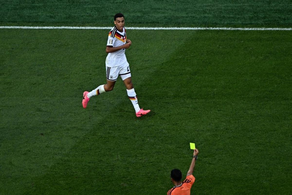 Moroccan referee Jalal Jayed shows a yellow card to Germany's midfielder #10 Jamal Musiala during the 2026 World Cup round of 32 football match between Germany and Paraguay at the Boston Stadium in Foxborough on June 29, 2026. Jewel SAMAD / AFP