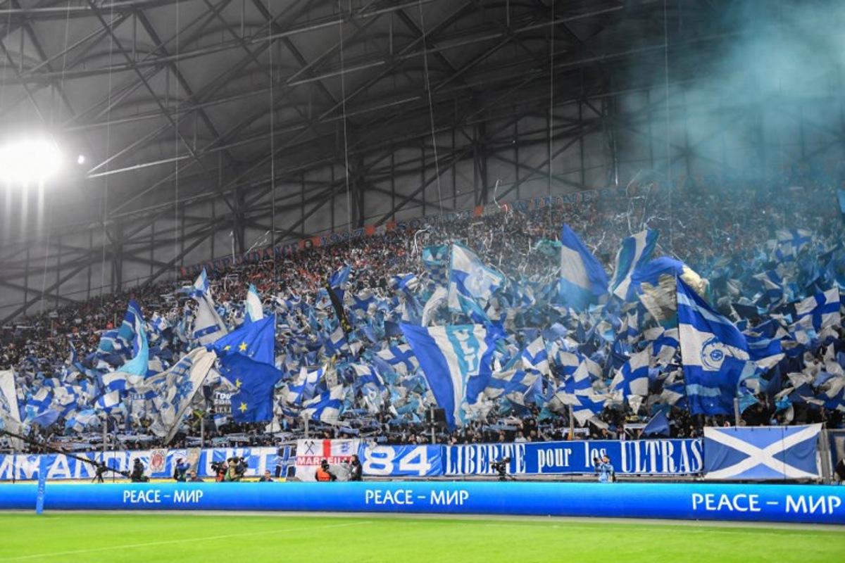 Marseille's supporters wave flags during the UEFA Europa League quarter final second leg football match between Olympique de Marseille (OM) and SL Benfica at the Stade Velodrome in Marseille on April 18, 2024. Sylvain THOMAS / AFP