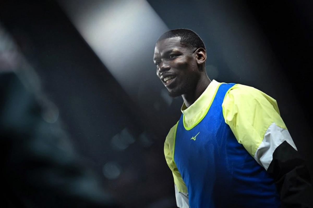 Monaco's French midfielder #08 Paul Pogba warms up prior to the French L1 football match between Stade Rennais FC and AS Monaco at the Roazhon Park stadium in Rennes, western France, on November 22, 2025. Lou BENOIST / AFP
