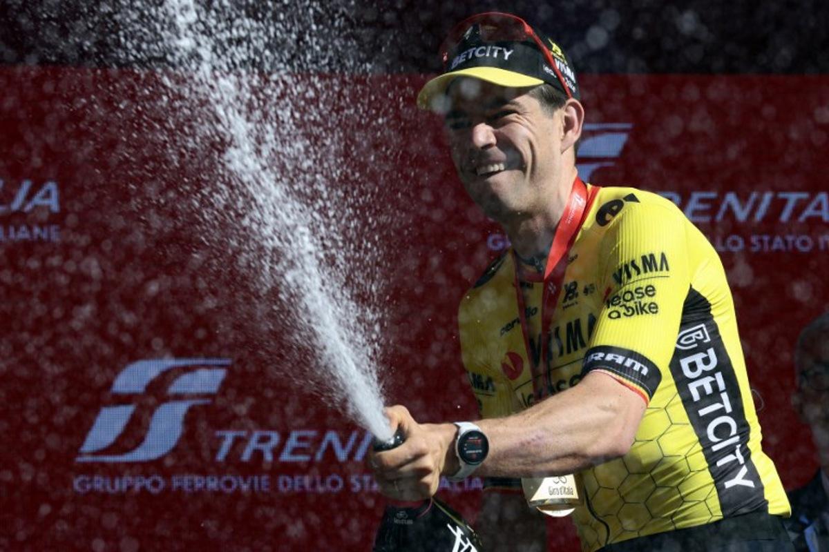Team Visma-Lease a Bike's Belgian rider Wout Van Aert celebrates on the podium after winning the 9th stage of the 108th Giro d'Italia cycling race of 181kms from Gubbio to Siena on May 18, 2025. Luca Bettini / AFP
