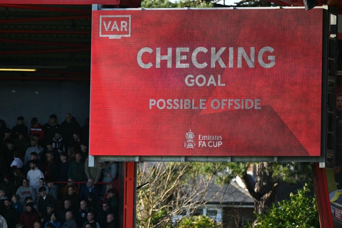 The big screen displays the news that a VAR (Video Assistant Referee) review is ongoing after Bournemouth's second goal, later disallowed for offside during the English FA Cup fifth round football match between AFC Bournemouth and Wolverhampton Wanderers at the Vitality Stadium in London on March 1, 2025. JUSTIN TALLIS / AFP