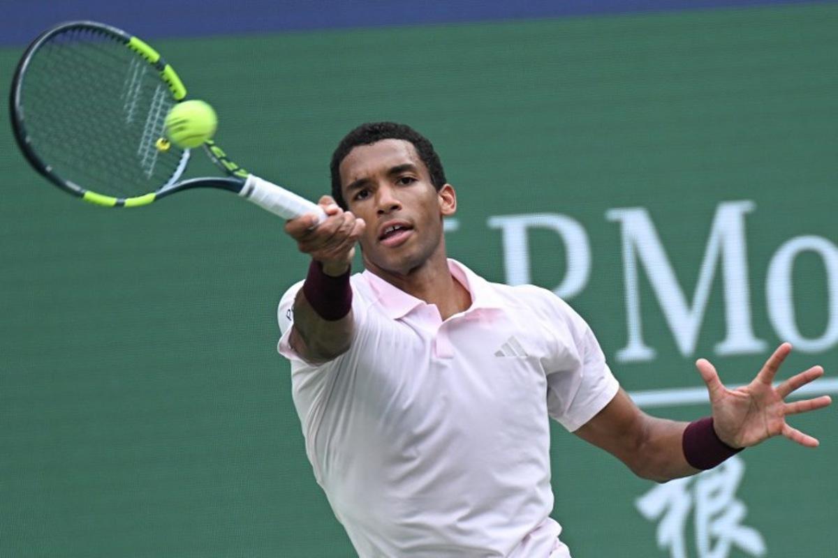 Canada's Felix Auger-Aliassime hits a return to Spain's Pablo Carreno Busta during their men's singles match at the Shanghai Masters tennis tournament in Shanghai on October 12, 2026. CN-STR / AFP