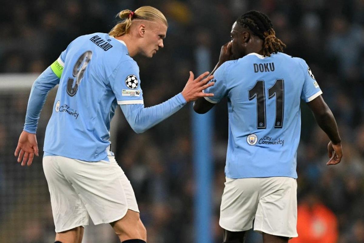 Manchester City's Norwegian striker #09 Erling Haaland (L) celebrates scoring his team's second goal with Manchester City's Belgian midfielder #11 Jeremy Doku during the UEFA Champions League football match between Manchester City and Borussia Dortmund at the Etihad Stadium in Manchester, north west England, on November 5, 2025. Oli SCARFF / AFP
