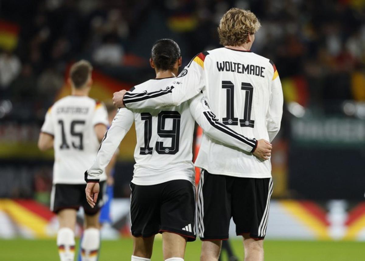 Germany's midfielder #19 Leroy Sane (L) celebrates with Germany's forward #11 Nick Woltemade scoring his team's third goal during the FIFA World Cup 2026 European qualification Group A football match between Germany and Slovakia, at the Red Bull Arena in Leipzig, eastern Germany on November 17, 2025. Odd ANDERSEN / AFP