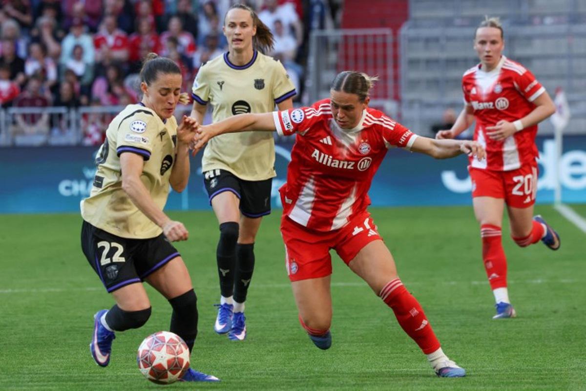 Barcelona's Spanish defender #22 Ona Batlle (L) and Bayern Munich's German forward #17 Klara Buehl vie for the ball during the UEFA Women's Champions League semi-final first leg football match between FC Bayern Munich and FC Barcelona in Munich, southern Germany on April 25, 2026. Karl-Josef HILDENBRAND / AFP