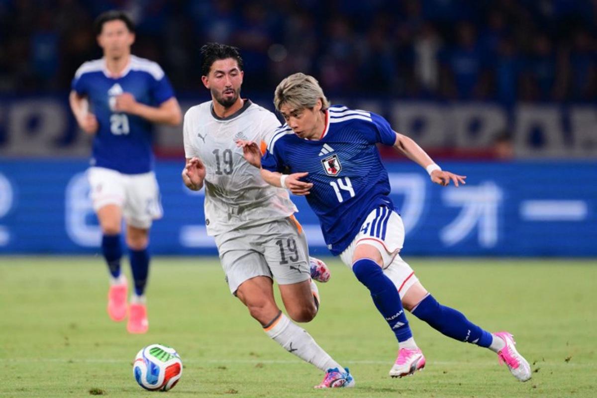 Japan's Junya Ito (R) and Iceland's Mikael Egill Ellertsson fight for the ball during the international friendly football match between Japan and Iceland at the National Stadium in Tokyo on May 31, 2026. Yuichi YAMAZAKI / AFP