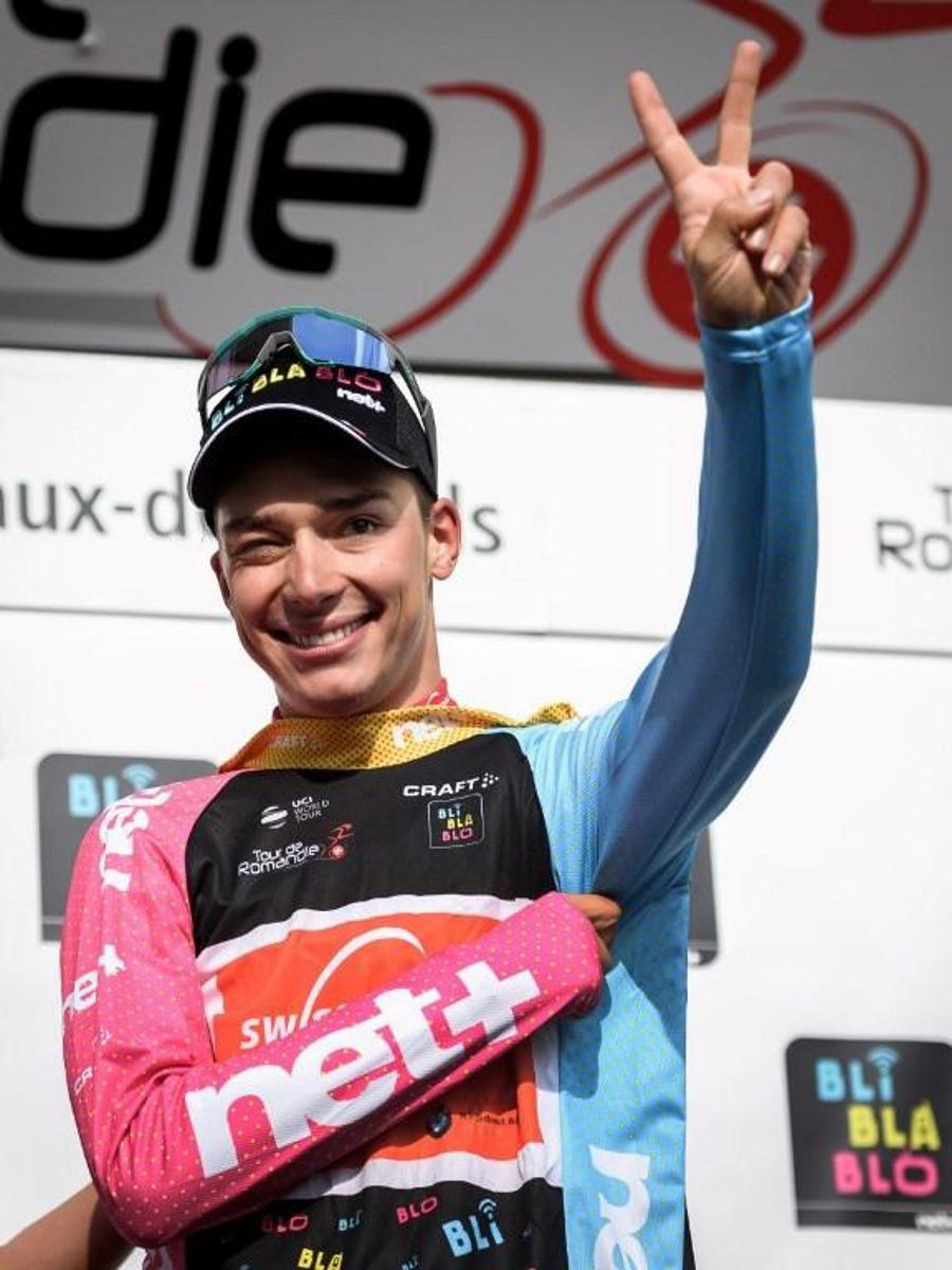 Switzerland's Simon Pellaud celebrates on the podium after winning the best climber's jersey during the 1st stage, 168,4 km from Neuchatel to La Chaux-de-Fonds, of the Tour de Romandie UCI World Tour 2019 cycling race, on May 1, 2019 in La Chaux-de-Fonds. Fabrice COFFRINI / AFP