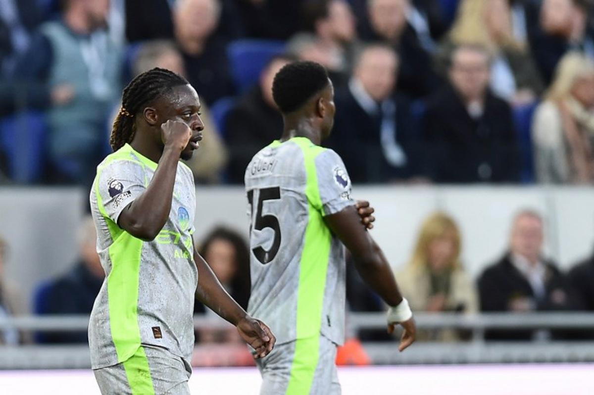 Manchester City's Belgian midfielder #11 Jeremy Doku celebrates after scoring the opening goal during the English Premier League football match between Everton and Manchester City at Hill Dickinson Stadium in Liverpool on May 4, 2026. PETER POWELL / AFP