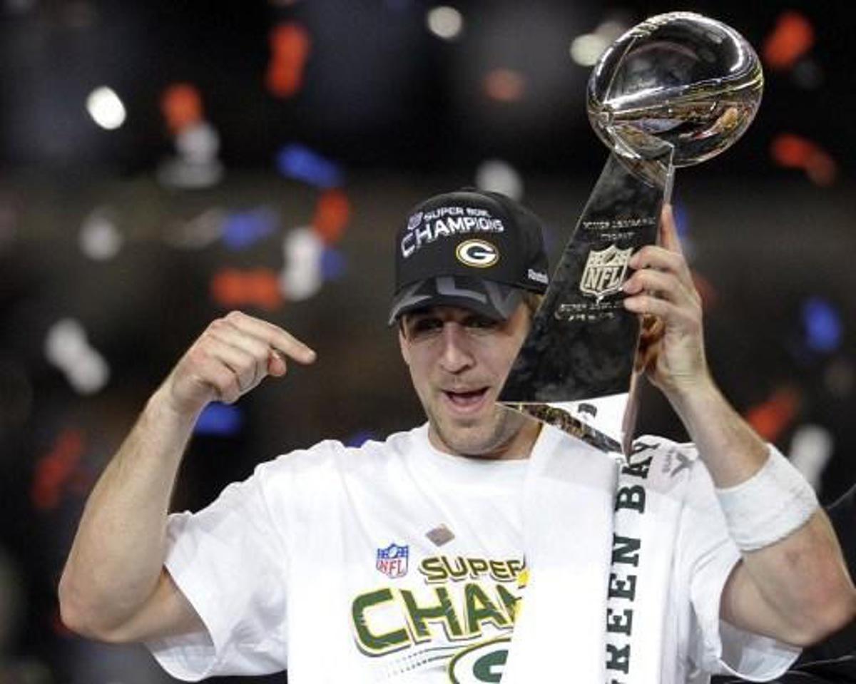 Green Bay Packers quarterback Aaron Rodgers celebrates with the trophy after the Packers defeated the Pittsburgh Steelers 31-25 in the NFL Super Bowl XLV football game at Cowboys Stadium on February 6, 2011 in Arlington, Texas. AFP PHOTO / TIMOTHY A. CLARY