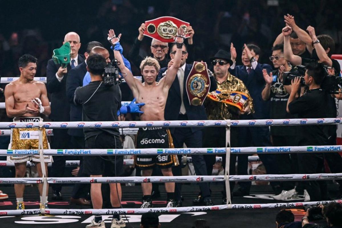 Naoya Inoue (C) celebrates defeating Junto Nakatani in their super bantamweight championship boxing contest at Tokyo Dome in Tokyo on May 2, 2026. Yuichi YAMAZAKI / AFP